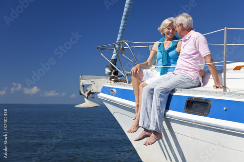 Foto : Happy Senior Couple Sitting on a Sail Boat Happy Senior Couple Sitting on a Sail Boat