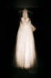 Dark Photo Of A White Wedding Dress On Black Background