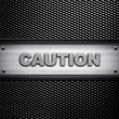CAUTION word on metal background