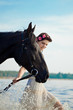 Woman on a horse by the sea
