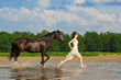 Woman on a horse by the sea