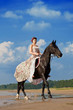 Foto: Woman on a horse by the sea Woman on a horse by the sea
