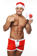 Image of sexy male wearing xmas costume and holding a gift