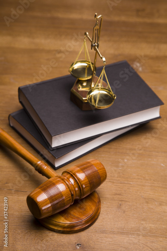 Photo: Gavel of justice and gavel on desk with dark background Gavel of justice and gavel on desk with dark background
