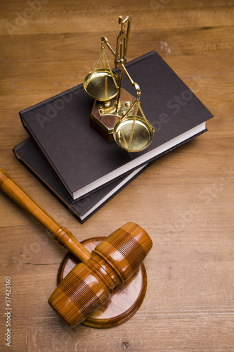 Photo: Gavel of justice and gavel on desk with dark background Gavel of justice and gavel on desk with dark background