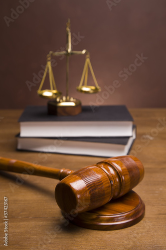 Photo: Gavel of justice and gavel on desk with dark background Gavel of justice and gavel on desk with dark background