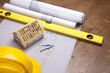 Construction plans and blueprints on wooden table