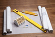 Construction plans and blueprints on wooden table