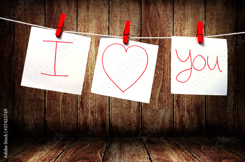 Photo: Note paper hanging on a rope, Love note concept Note paper hanging on a rope, Love note concept