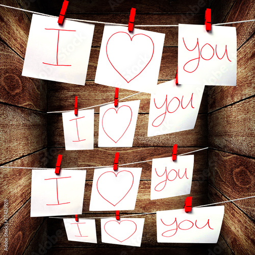 Photo: Note paper hanging on a rope, Love note concept Note paper hanging on a rope, Love note concept