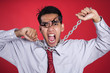 Freustrated businessman with chain shot over red