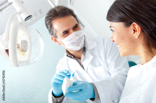Photo: Dentist showing how to brush teeth Dentist showing how to brush teeth