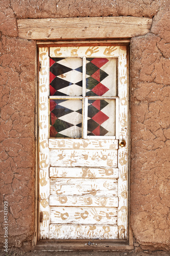 Photo: Decorated Door and Adobe Building Decorated Door and Adobe Building