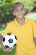 African American Boy Child Playing With Football or Soccer Ball