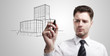 Business man drawing a project of building on a glass window