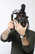 Man with HD SLR camera and audio equipment