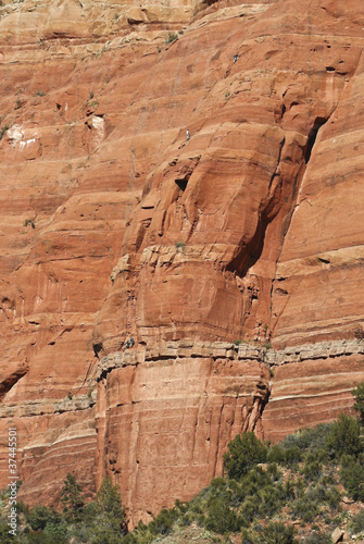 Photo: A Team of Climbers Ascend a Sandstone Cliff A Team of Climbers Ascend a Sandstone Cliff