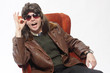 Man with mullet sitting in chair.