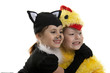 Photo: Two girls play in fancy dress of a chicken and cat. Isolated whi Two girls play in fancy dress of a chicken and cat. Isolated whi