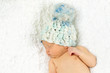 Newborn Baby Sleeping with knitted Hat on.