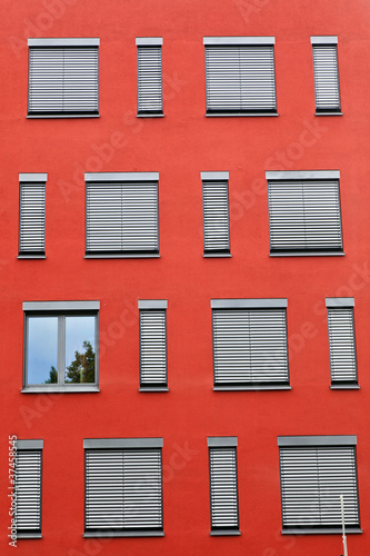 Photo: pattern of windows with red wall pattern of windows with red wall
