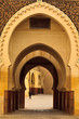 Ornate arches of passageway into mosque courtyard Morocco