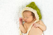 Newborn Baby Sleeping with knitted Hat on.