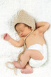 Newborn Baby Sleeping with knitted Hat on.