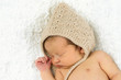 Newborn Baby Sleeping with knitted Hat on.