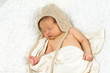 Newborn Baby Sleeping with knitted Hat on.