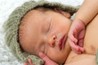 Newborn Baby Sleeping with knitted Hat on.