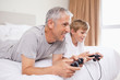Smiling father and his son playing video games
