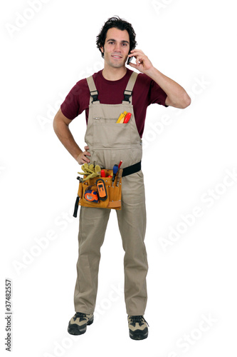 Photo: Repairman talking on a cellphone Repairman talking on a cellphone