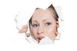 young woman looking out from hole in paper