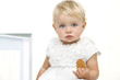 Boring looking baby with biscuit in hand