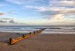 Wooden Wave Breaker on the Sandy Beach Wooden Wave Breaker on the Sandy Beach
