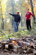 Photo: Campfire in forest with young people in background Campfire in forest with young people in background