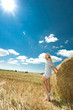 Girl at a stack of straw