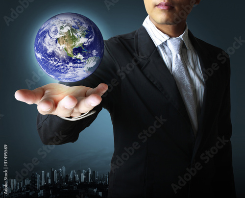 Photo: holding a glowing earth globe in his hand holding a glowing earth globe in his hand
