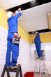 Electrician wiring a large tiled room