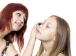 The girl does eyelashes to the little girl