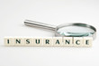 Insurance word and magnifying glass