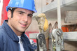 Tradesman standing next to a hoist