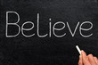 Believe, written with chalk on a blackboard. Believe, written with chalk on a blackboard.