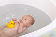 newborn baby girl having her first bath.