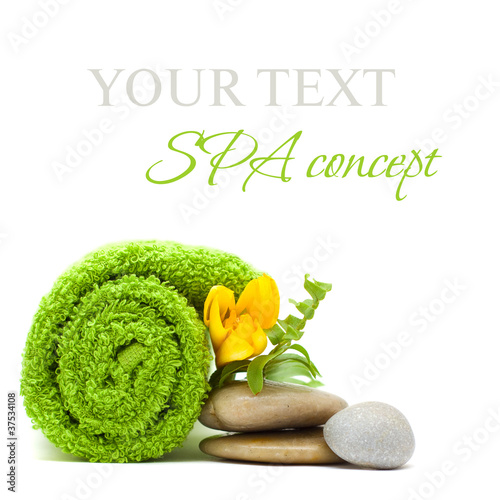Photo: Spa concept - stones, green leaves and flower isolated on white Spa concept - stones, green leaves and flower isolated on white