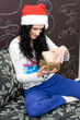 Caucasian girl in santa hat with gift Caucasian girl in santa hat with gift
