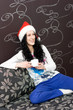Young caucasian woman with cup of tea in santa hat Young caucasian woman with cup of tea in santa hat