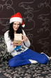 Caucasian girl in santa hat with gift Caucasian girl in santa hat with gift