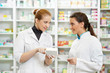 Pharmacy chemist women in drugstore